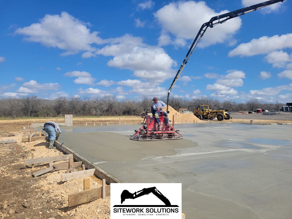 Laying the asphalt using a paving machine to spread by Siteworks Solutions in San Antonio Texas